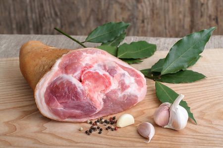 Raw pork knuckle with pepper. garlic and bay leavesの写真素材