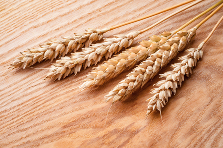 ripe wheat ears on wooden backgroundの写真素材