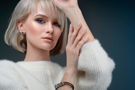 Closeup face of beautiful woman with smoky eyes make-up and light lipstick. Portrait of an attractive girl in the studio.の写真素材