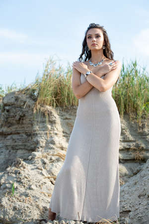 Gorgeous portrait of a girl in a long dress and silver jewelryの写真素材