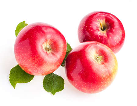 fresh red apples with leaves isolate on white backgroundの写真素材