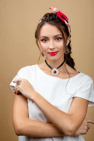fashionable woman in luxury silver jewelry posing in studio isolated on yellow backgroundの写真素材