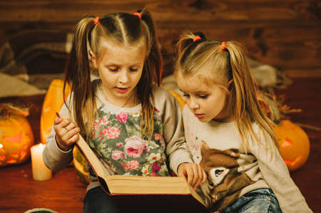 Two girls preparing for the holiday. Night, candles, pumpkin, tales.の写真素材