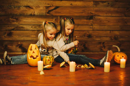Two girls preparing for the holiday. Night, candles, pumpkin, tales.の写真素材