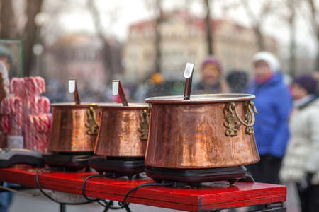 Street food. Hot mulled wine. Steam over hot wine pots. Outside. Close-up photo.の写真素材