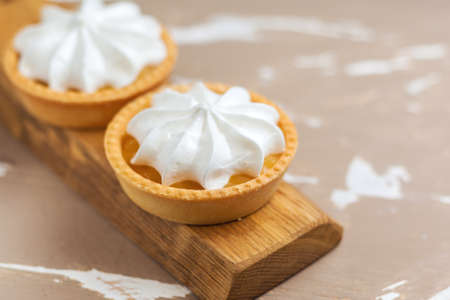Lemon tart. Two cakes on a wooden plate. Selective focusの写真素材
