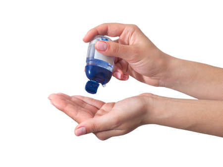 Hand disinfection. hand takes alcohol disinfectant gel on her hands. Isolated on a white backgroundの写真素材