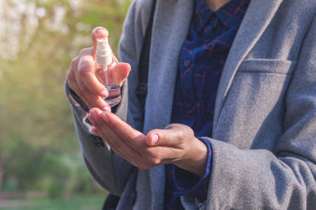 Hand disinfection. hand takes alcohol disinfectant spray on her hands. to prevent a viral epidemicの写真素材