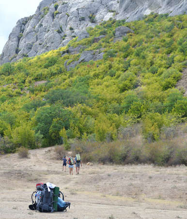 Tourists in the mountains are on the footpath, travel backpacksの写真素材