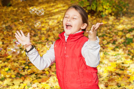 girl  catches bubbles from the soapの写真素材
