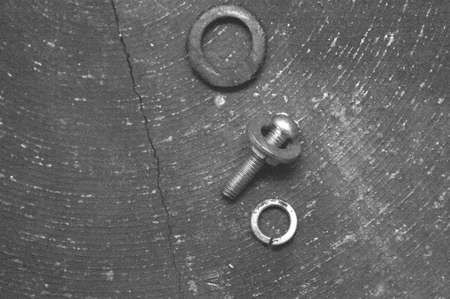 a still-life of a small bolt and a few washers lying on a benchの写真素材