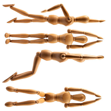 wooden mannequin of a man on hinges in the poses of a swimmerの写真素材