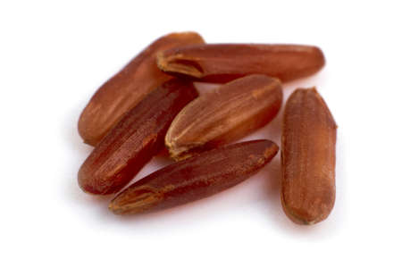 Brown rice grains close up on white backgroundの写真素材