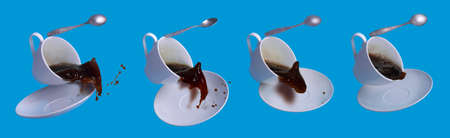 Levitation of a Cup of coffee with a saucer and a spoon with spilling (splash) coffeeの写真素材