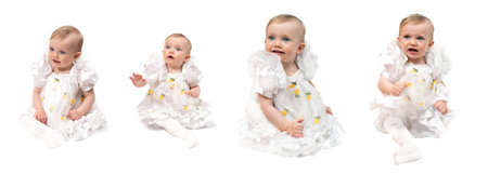 A one-year-old girl with blonde hair and blue eyes. In a white airy dress and white tights. Different shooting angles. Full-length. Different emotions. On a white background.の写真素材