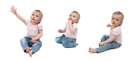 A one-year-old child with blonde hair and blue eyes, wearing a light pink T-shirt and blue jeans. Different shooting angles. Full-length. Different emotions. On a white background.の写真素材