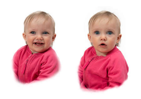 Close-up of a one-year-old child with blonde hair and blue eyes, in a pink jacket. Different camera angles. Waist portrait. Different emotions.の写真素材