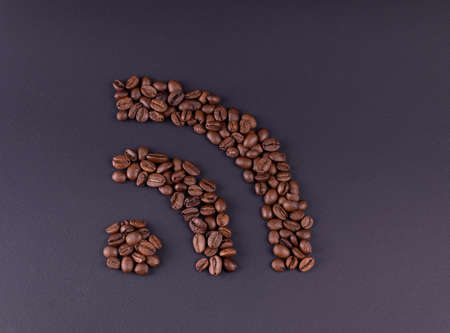 Sign wi fi laid out coffee grains on a dark background