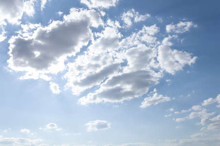 summer bright blue sky with airy white clouds in the form of a picture floating in the distance