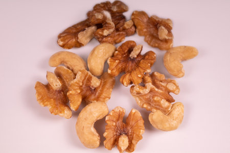 mix of cashews and walnuts on white backgroundの写真素材
