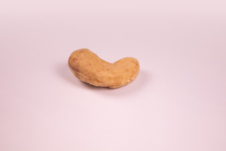 peeled cashew nuts close up on isolated white backgroundの写真素材