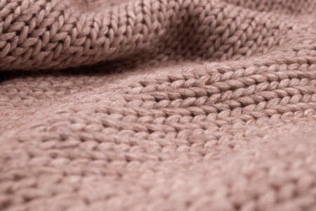 Beautiful folds on a crumpled knitted bedspread in light color