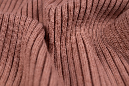 beige knitted fabric laid in wavesの写真素材