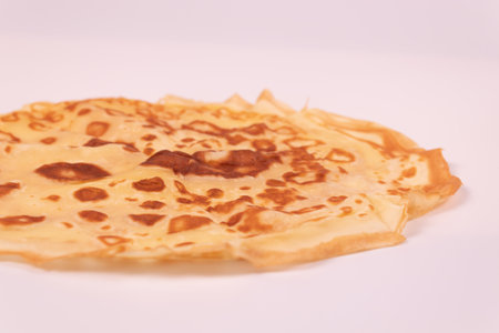 yellow pancake with spots diagonal viewの写真素材