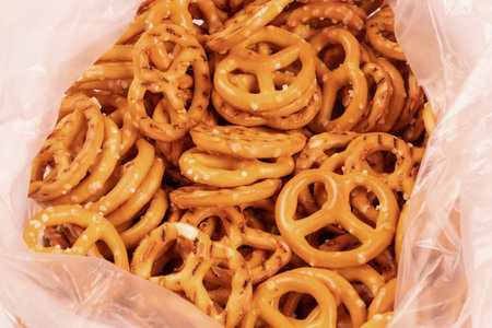 yellow pretzels in a pink bagの写真素材