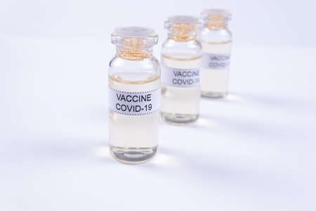 three ampoules with the Covid-19 vaccine are in a rowの写真素材