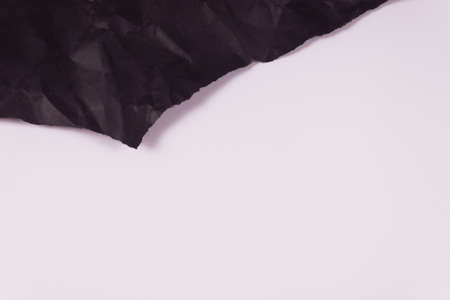 at the top of the frame, a piece of black crumpled paper is visible, torn at the edgesの写真素材