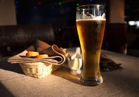 beer standing on a table covered with a tablecloth in a cafe