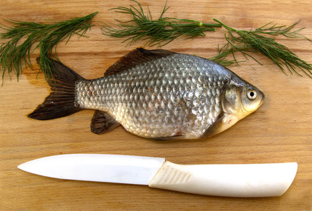 Raw fish lying on wooden cutting boardの写真素材