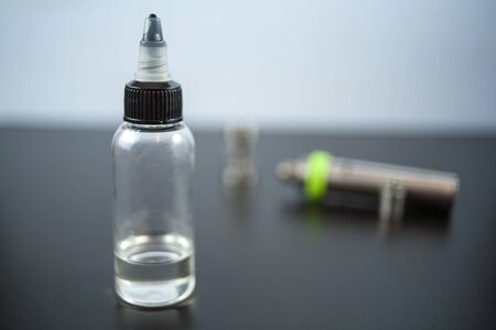 Jar with fluid for personal vaporisers for background. Electronic nicotine delivery systems. ENDS.