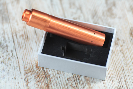 Electronic cigarette in white box on the table. Mechanical mod. ENDS.の写真素材