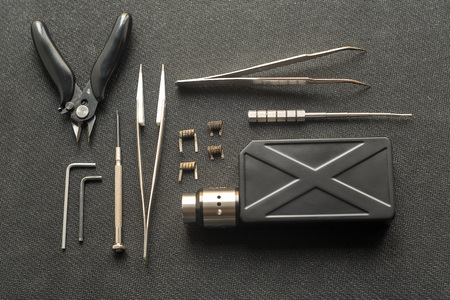 Vape. Tools for repair and maintenance of the electronic cigarette on the black background. Top view.の写真素材