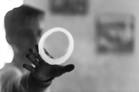 Vape. Man hand and a ring of steam. Vaping. Electronic cigarette. Black and white photo.