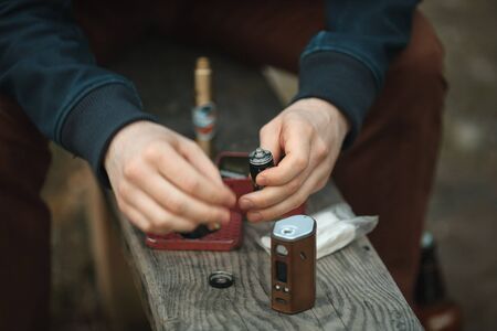 Vape. Electronic cigarette in male hands. Close up.の写真素材