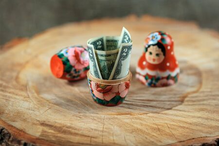 Russian doll with dollars inside. Anti crisis money box. Matrioska bank.の写真素材