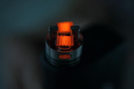 Glowing spiral of the electronic cigarette for background. Personal vaporizer. ENDS.