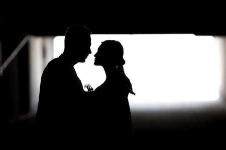 Silhouette of a couple in love. Black and white photo.の写真素材