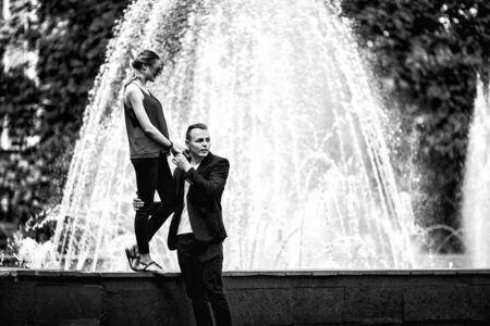 Couple in love next to the fountain on a sunny day. Black and white photo.の写真素材
