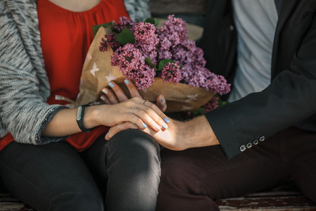 Couple in love on the bench with purple flowers.