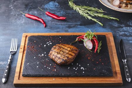 Juicy griiled beef steak served with fork and knifeの写真素材