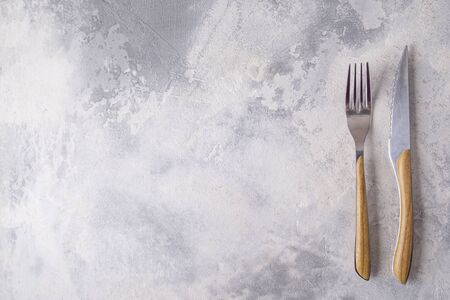 Top view of fork and knife over gray background. Space for textの写真素材