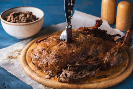 Baked duck with buckwheat and mushrooms on a wooden board. Sruffed duckの写真素材