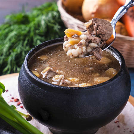 Tasty soup with meat and mushroom in a pot. Closeupの写真素材