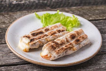 Suluguni cheese in lavash on a plate.の写真素材