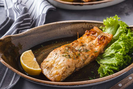 Grilled sturgeon on a plate. Grilled white fish