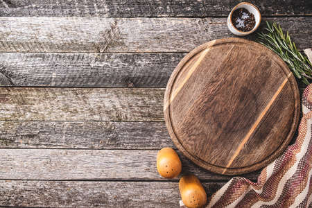 Cutting board for cooking with spices and herbs. Top view of round cutting board with copy space.の写真素材